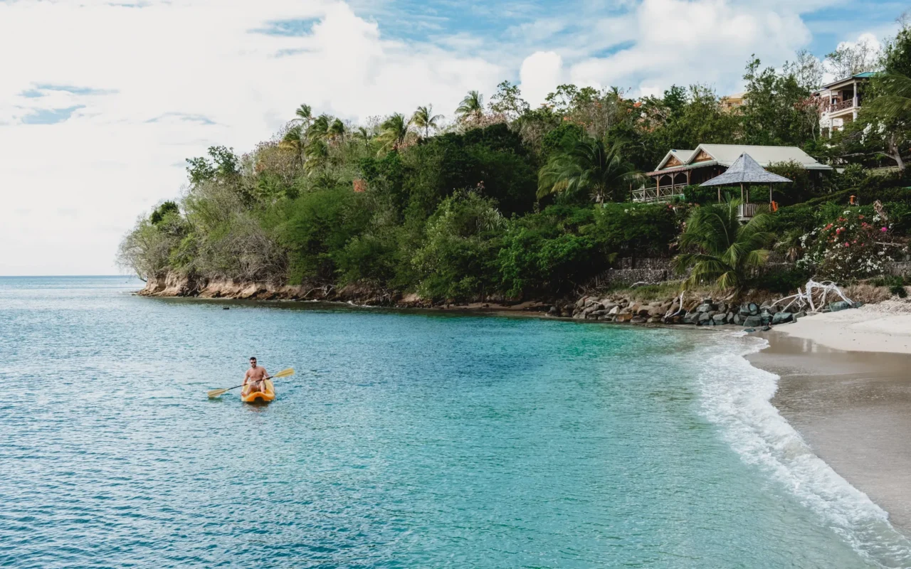 Man on a kayak on clear Saint Vincent waters